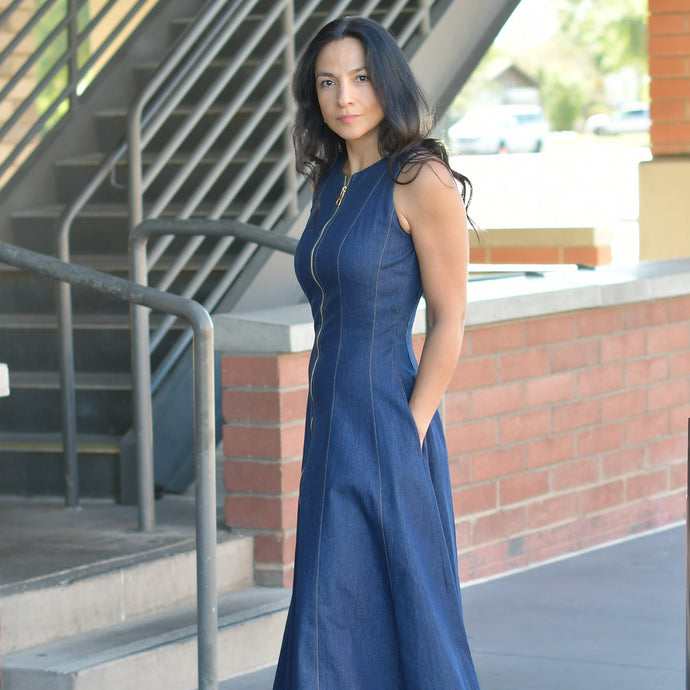 Woman in a denim dress with fron zipper and pockets
