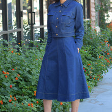 Woman wearing denim outfit rounded skirt with pockets