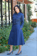 Woman wearing denim rounded skirt and denim jacket